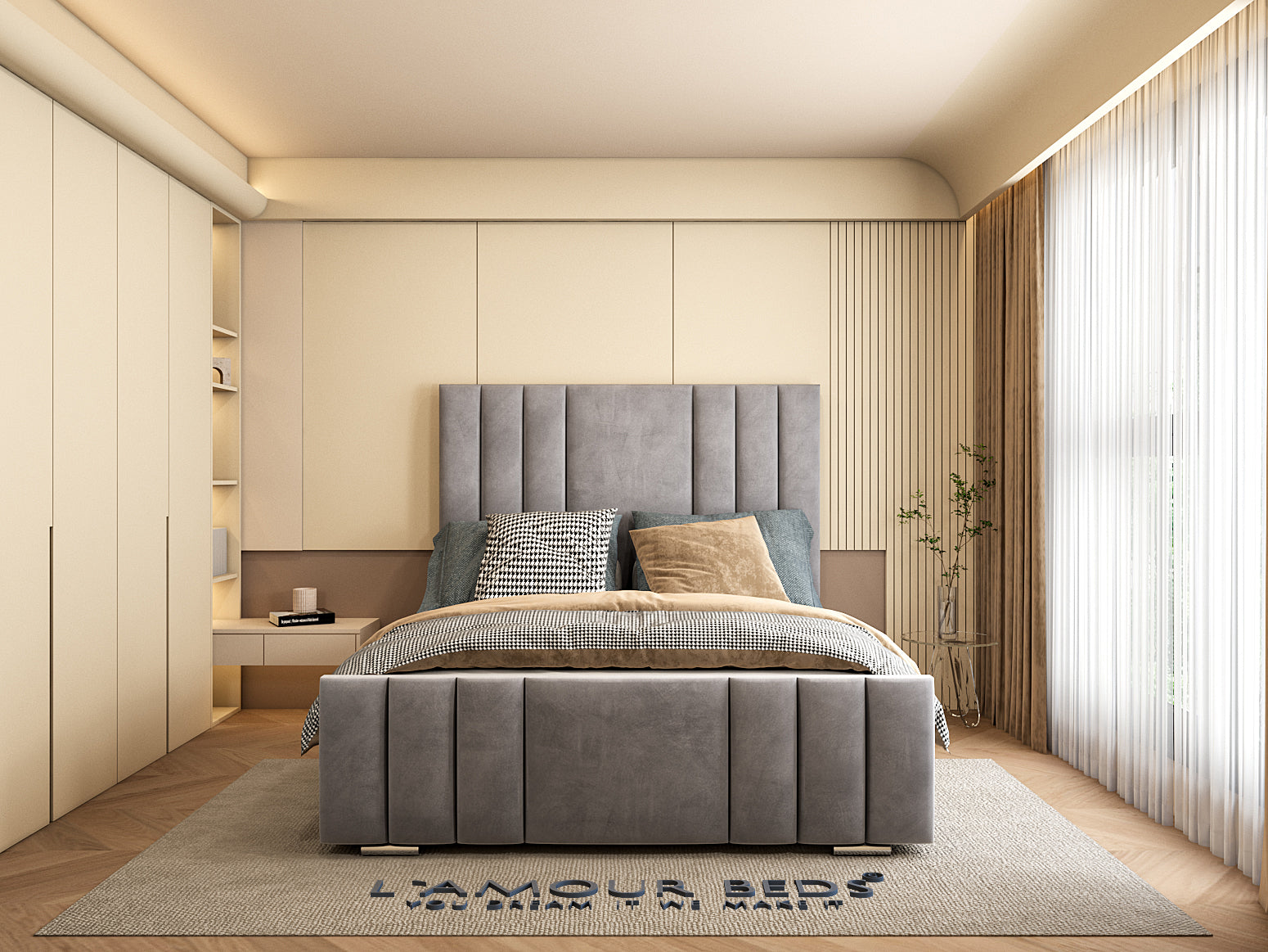 Cozy bedroom with a stylish gray upholstered bed, large windows with sheer curtains on the side, and a beige-toned decor creating a calm and inviting ambiance.